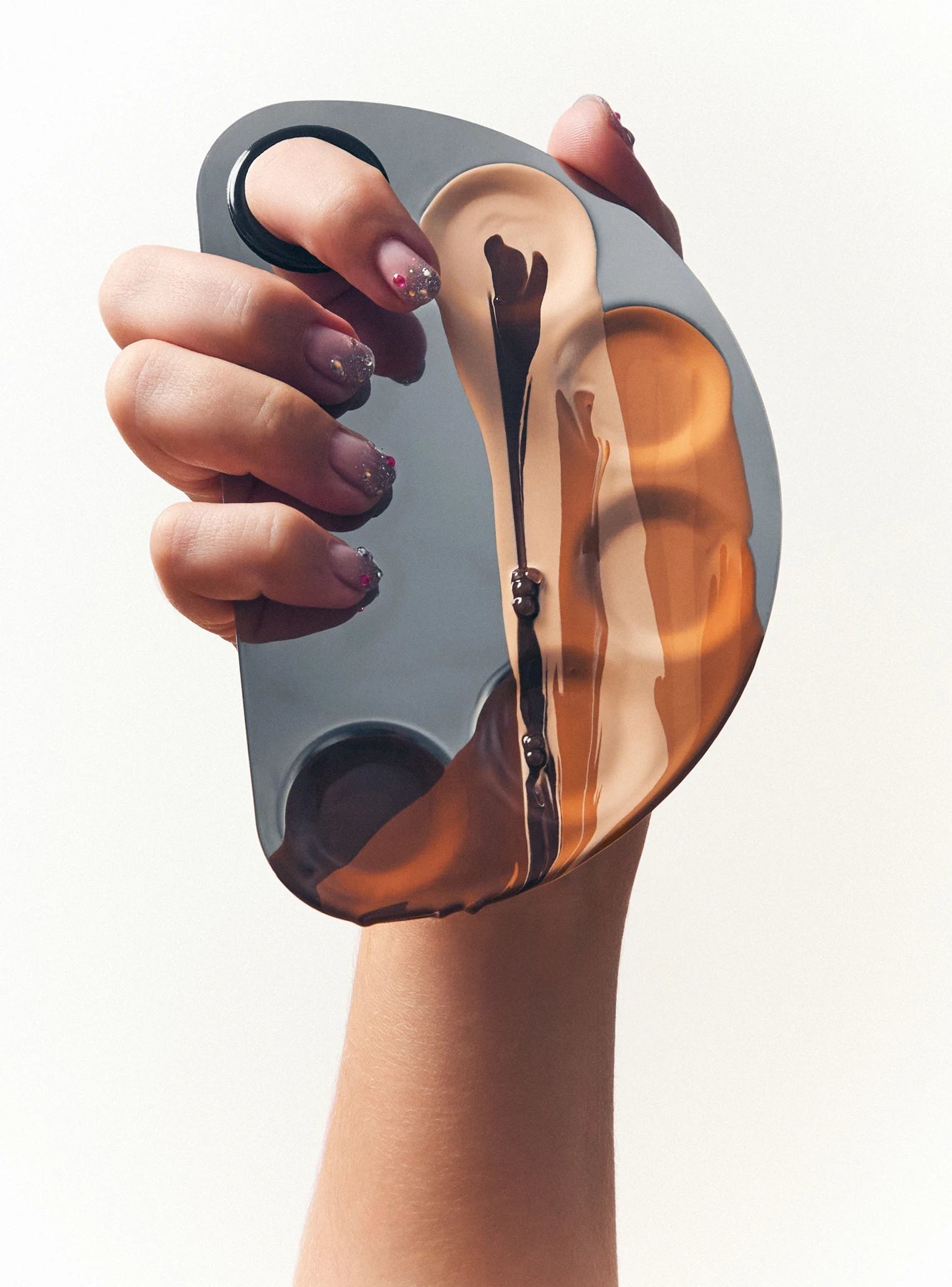 Hand holding a Yumay compact foundation
