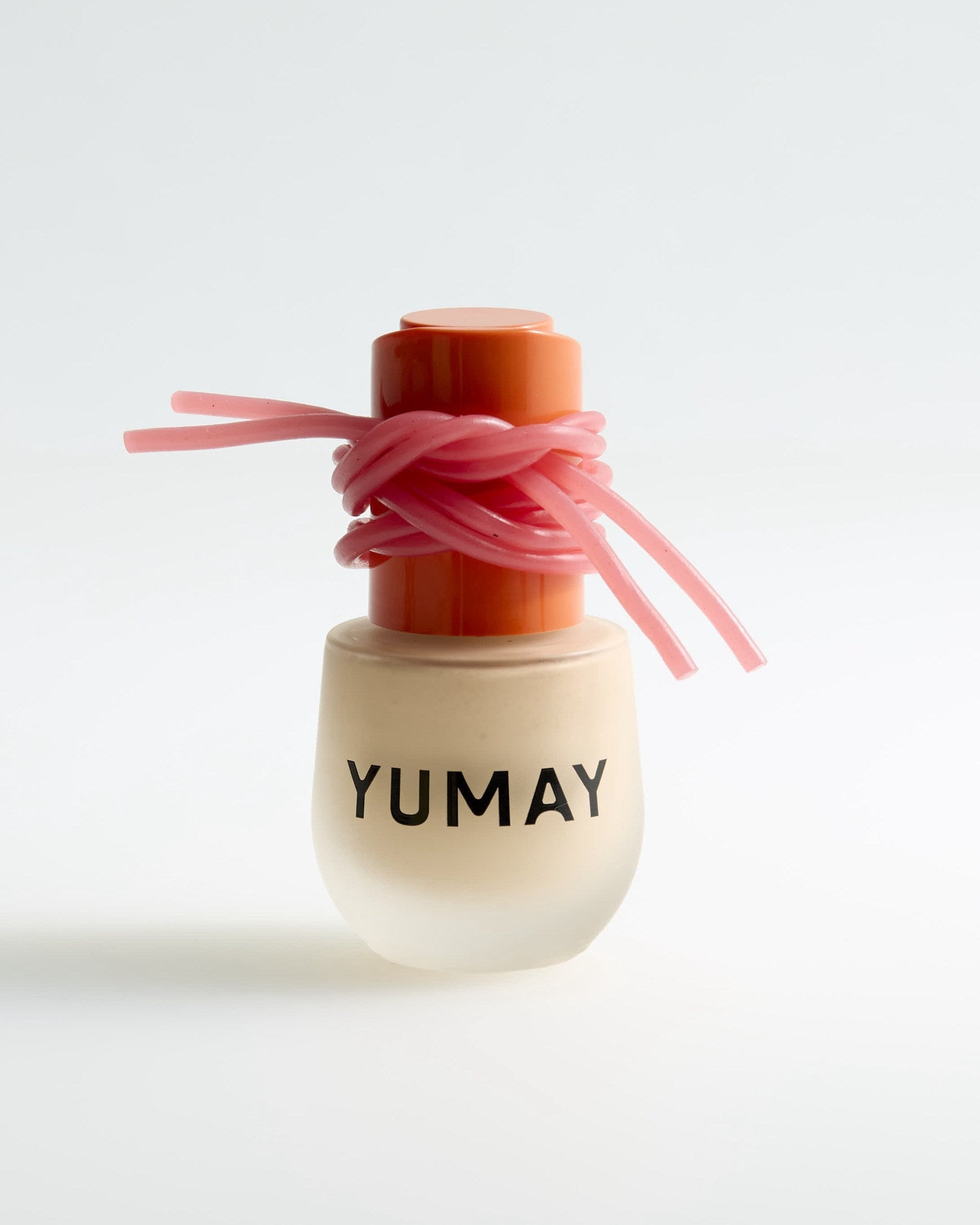 YUMAY foundation finished with a pink ribbon